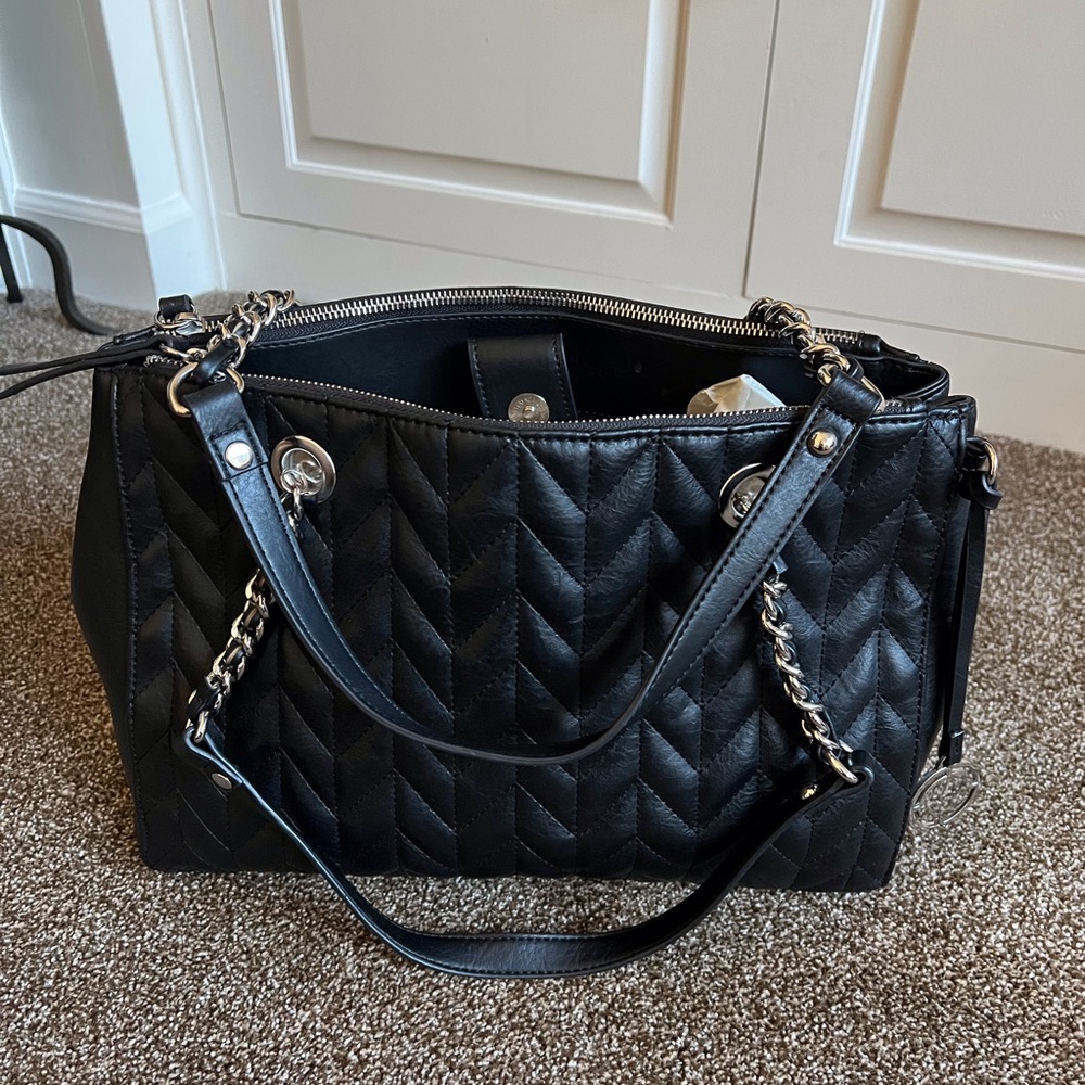 Nicole Miller black, leather, quilted handbag with silver chain link handle.